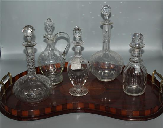 Five cut glass decanters and an inlaid mahogany kidney-shaped tray